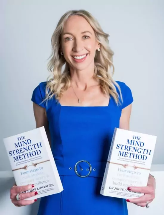 dr-jodie-mental-health-speaker Dr Jodie holding her book The Mind Strength Method