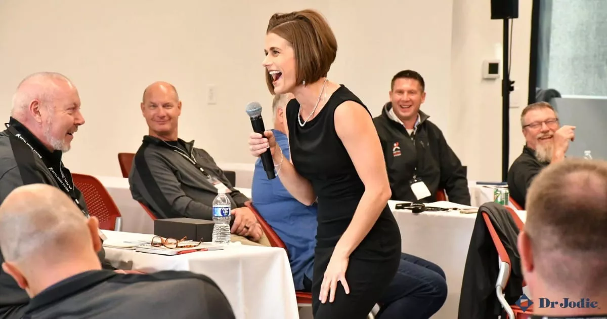 Corporate audience engaging with a keynote speaker during an in-person conference session